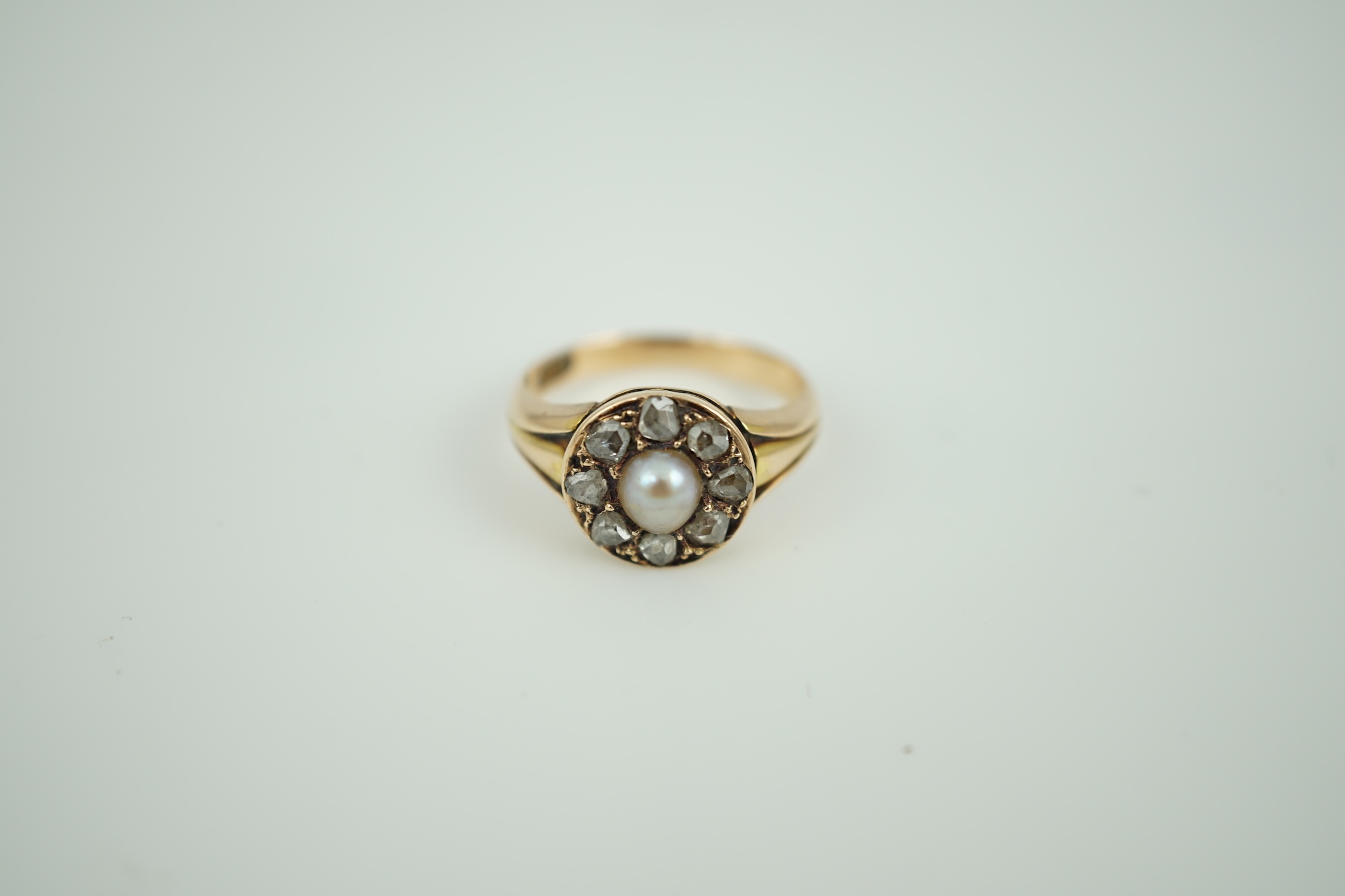 A Victorian 15ct gold, spilt pearl and rose cut diamond set circular cluster ring, size L, gross weight 4.4 grams.